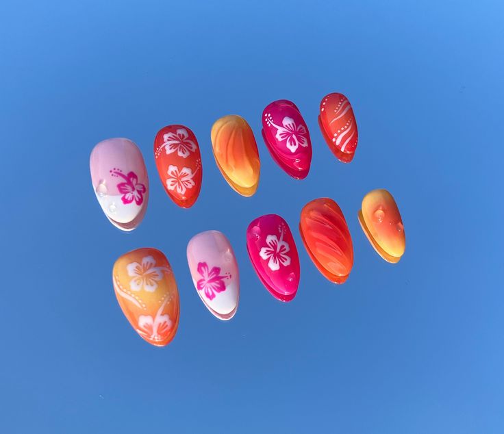 Vibrant Tropical Floral Nail Designs with Intricate Gradient Effects.