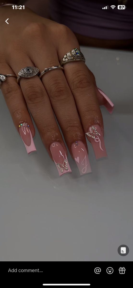 Elegant Whimsical Manicure: Soft Pink Shades with Intricate Butterflies and Delicate Accents