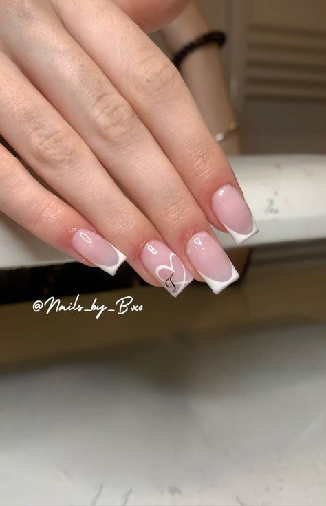 Charming Elegant Nail Design: Soft Pink Base with White Tips and Heart Outline.