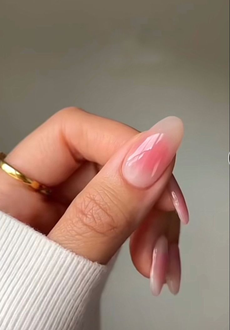 Elegant Ombre Nails in Soft Pink with Glossy Finish and Sophisticated Gold Ring Accent.