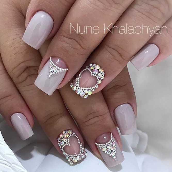 Elegant Nude Nail Design with Intricate Crystal Embellishments for Special Occasions