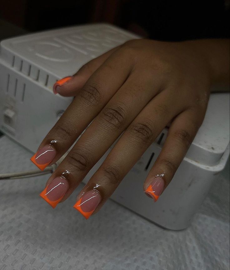 Bold Peach and Neon Orange Nail Design with Elegant Silver Accents.