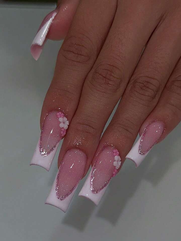 Sophisticated Nail Design Showcasing Soft Pink and White Tones with Floral Accents.