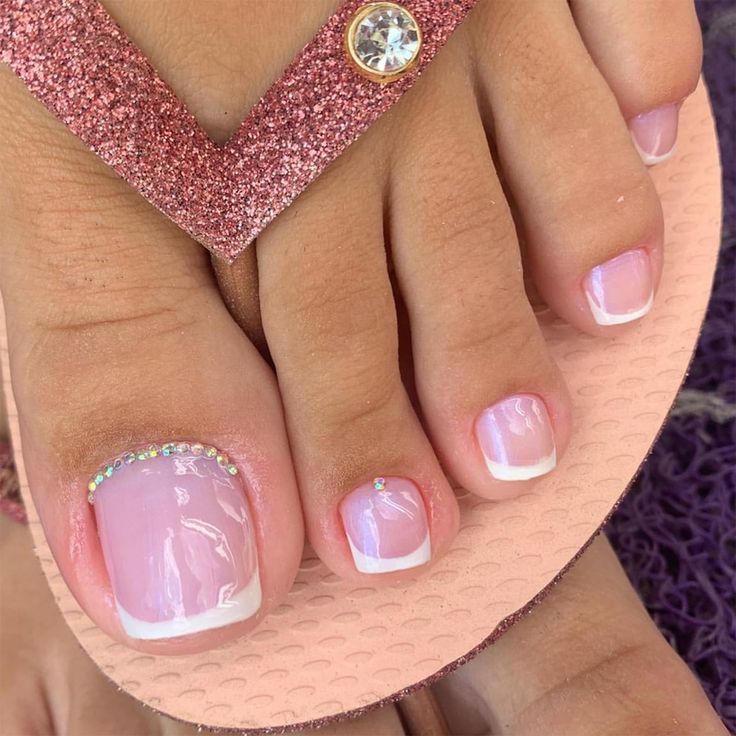 Chic Pink Pedicure with Elegant White Tips and Sparkling Rhinestone Accents