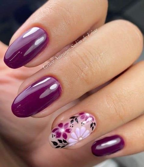 Chic Deep Purple Manicure with Floral Accents and Glossy Finish.