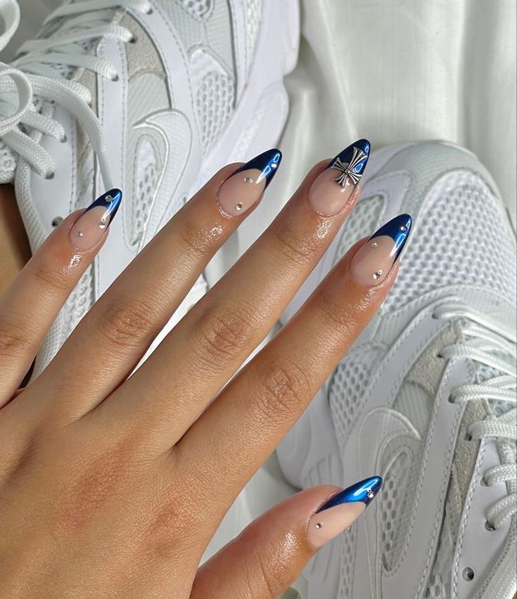 Chic Stiletto Nail Design with Nude-Blue Gradient and Decorative Elements.