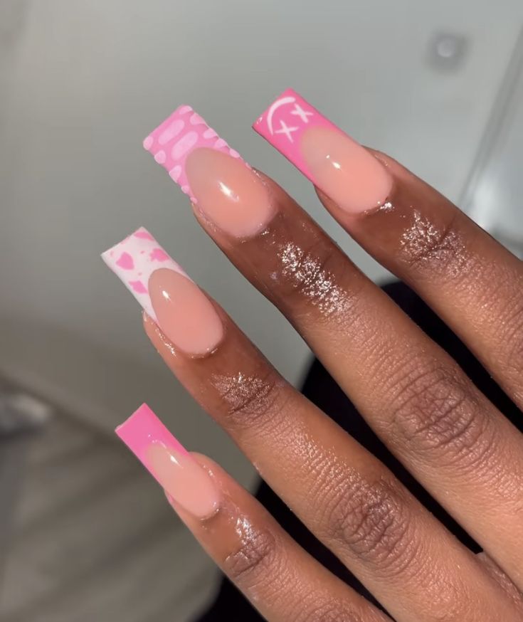 Chic Pink Nail Design with Playful Patterns and Artistic Flair