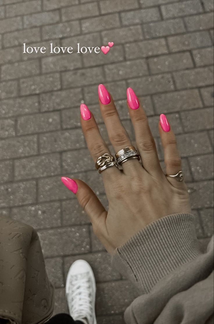 Bold Hot Pink Nails and Eye-Catching Rings: A Trendy Expression of Individuality.