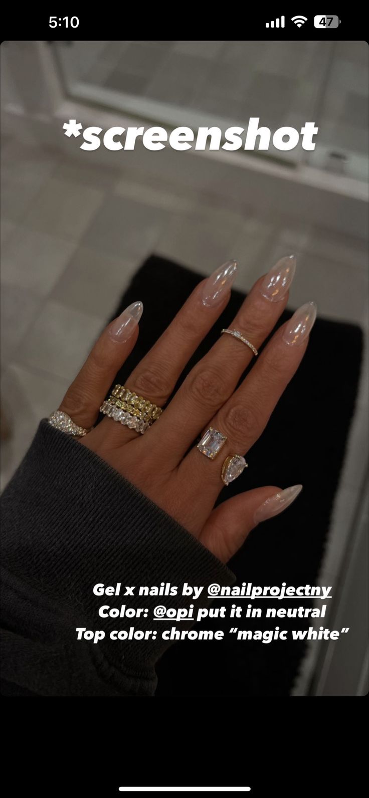 Elegant Chrome-Topped Almond Gel Nails with Neutral Base and Statement Rings.