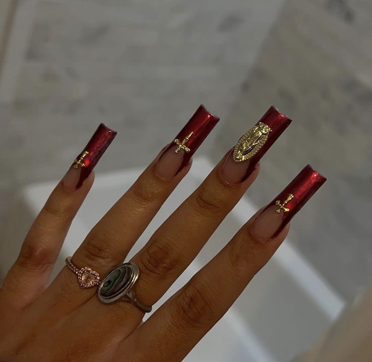 Striking Red Nail Design: Glossy Square Tips with Gold Embellishments for Elegant Sophistication.