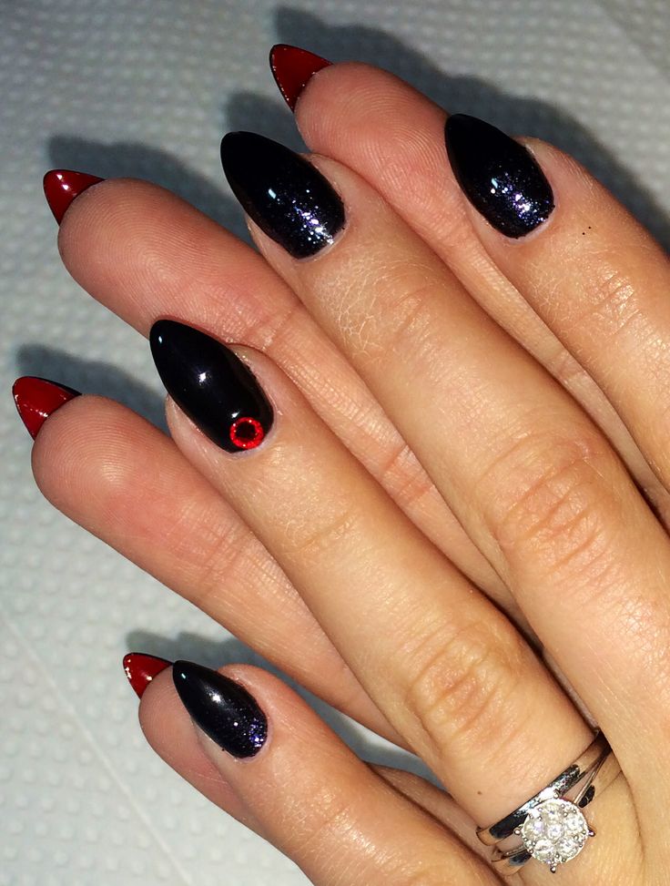 Chic Almond-Shaped Nail Design: Glossy Black and Vibrant Red with Unique Accent