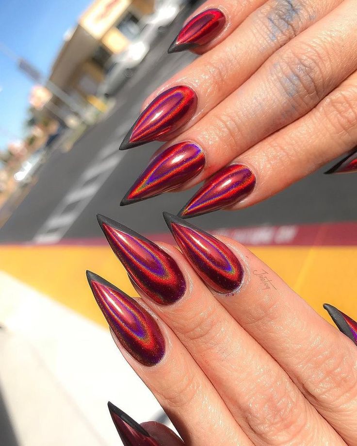 Bold Red and Black Elongated Nail Design with Mesmerizing Holographic Gradient Effect.