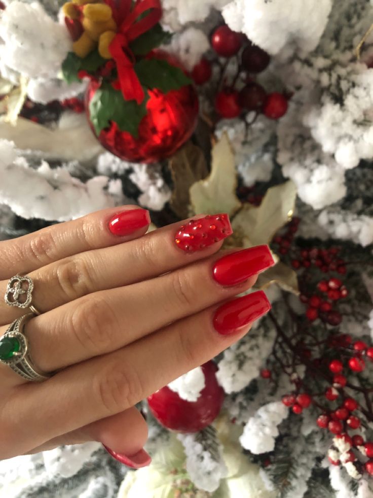 Festive Red Nail Design with Whimsical Accent for Holiday Cheer