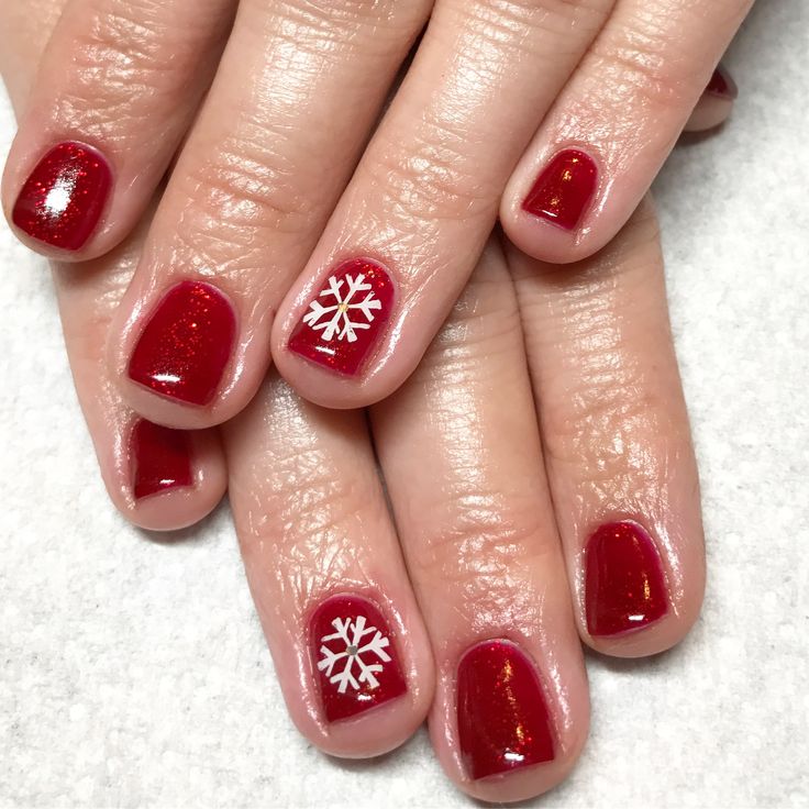 Festive Elegant Red Nail Design with Glossy and Glitter Finishes and Delicate Snowflake Accent