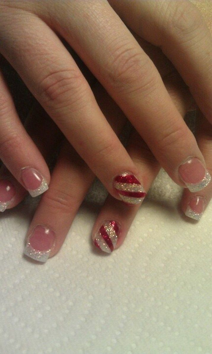 Chic French Manicure with Glittery Silver Tips and Festive Red Accents.