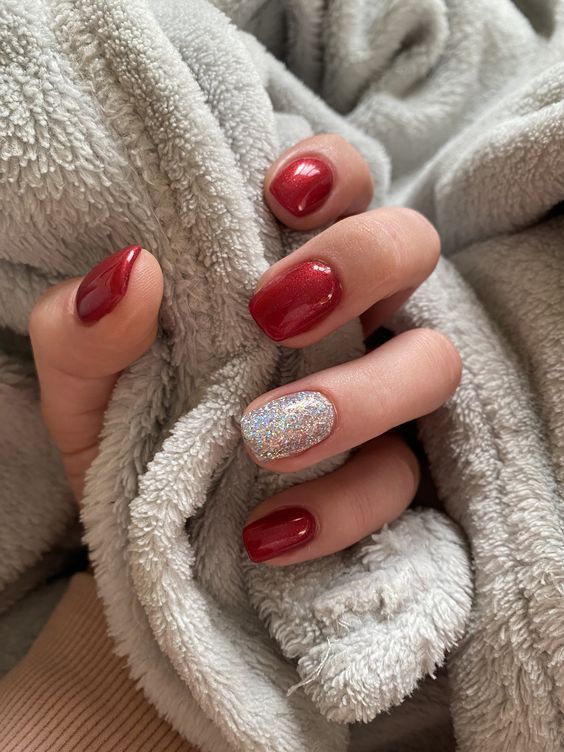 Sophisticated Deep Red Nail Design with Sparkling Silver Accent.