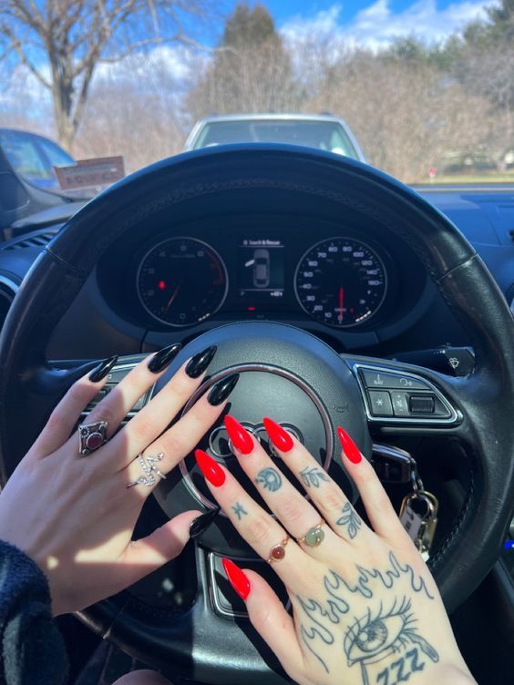 Bold Red and Black Nail Art: Edgy Designs Enhanced by Car Interior Backdrop