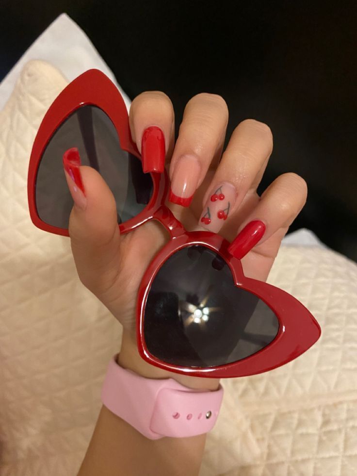 Playful Red and Nude Nail Design with Cherry Accent for a Flirty Summer Look.