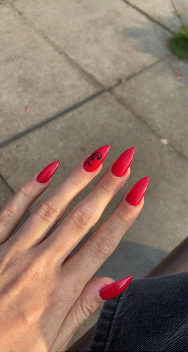 Vibrant Bold Red Almond-Shaped Manicure with Striking Black Accent Design.