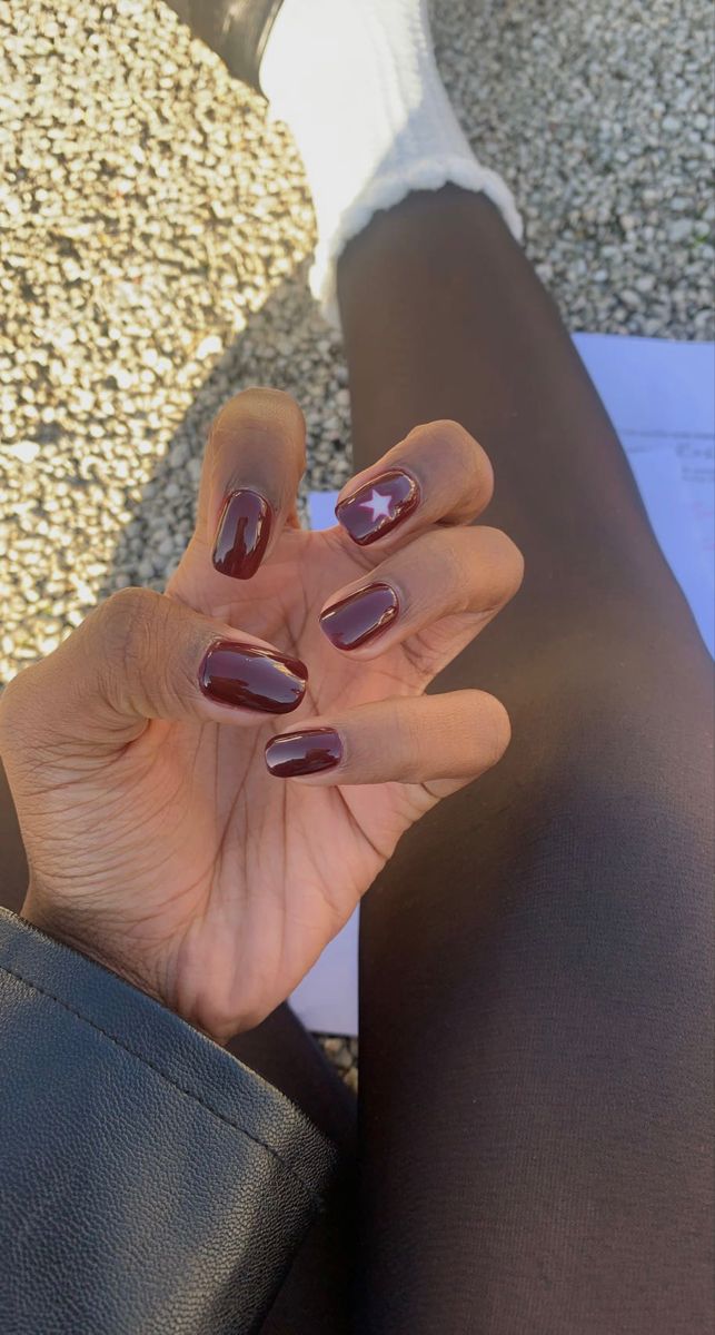 Elegant Burgundy Nails with Glossy Finish and Whimsical Star Design