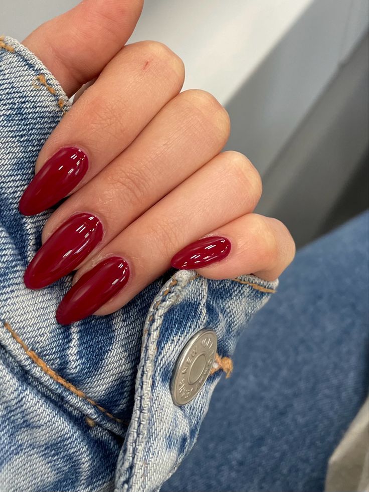 Sophisticated Almond-Shaped Nails in Deep Burgundy: A Chic Complement to Denim.