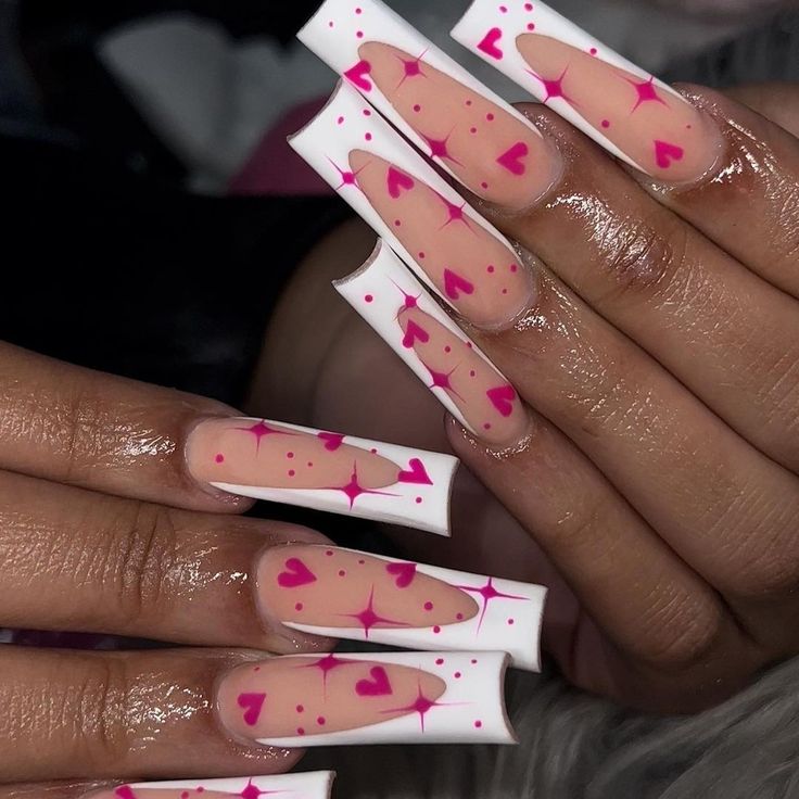 Charming Playful Nail Design: Glossy Elongated Tips with Pink Hearts and Delicate Speckles