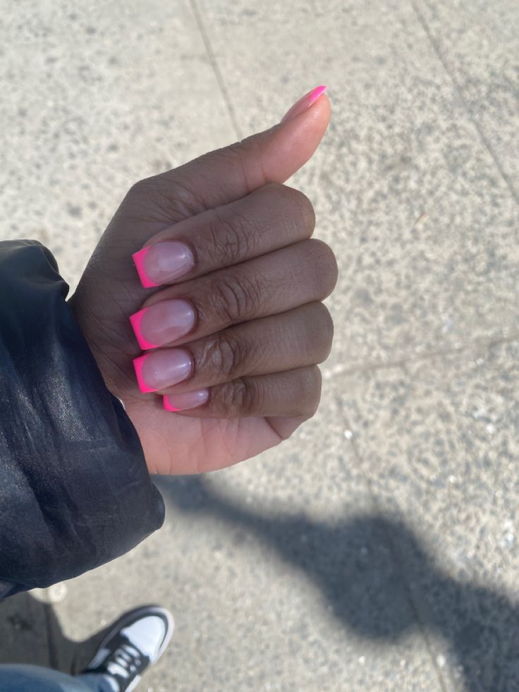 Chic Modern French Tip Manicure: Classic Nude Base with Vibrant Hot Pink Tips.