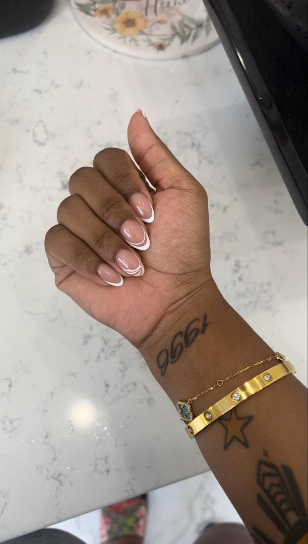 Sophisticated Glossy Nude French Manicure Accented with Stacked Jewelry.