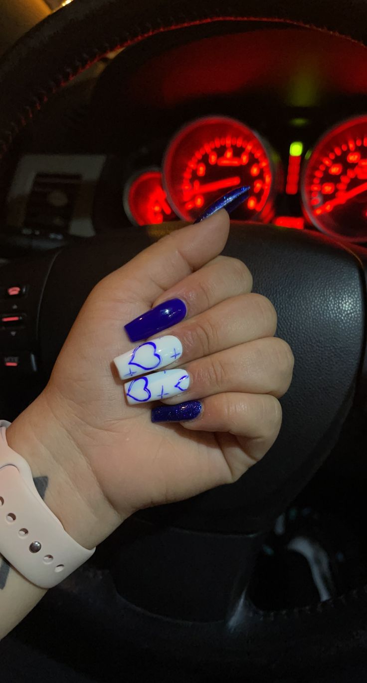 Bold Blue and White Nail Design with Abstract Heart Patterns for a Stylish Statement.