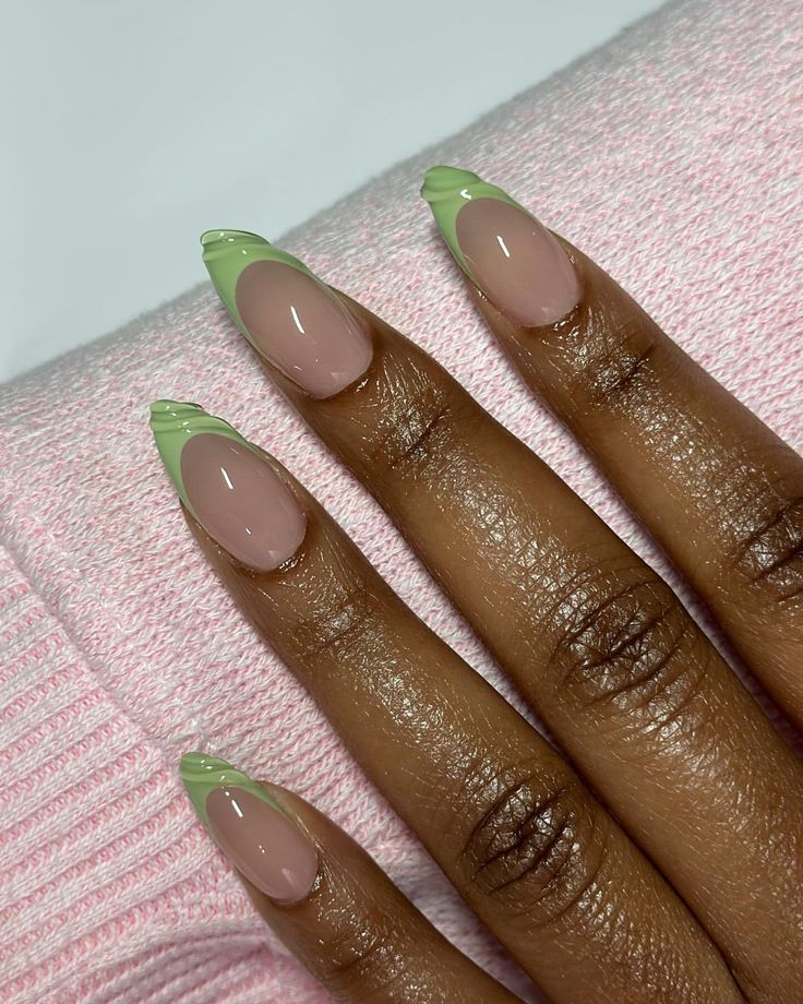 Chic Nail Design: Soft Nude Base with Playful Green Tips and Wavy Accents.