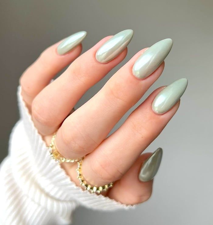 Chic Pale Green Nail Design with Glossy Finish and Dainty Rings.