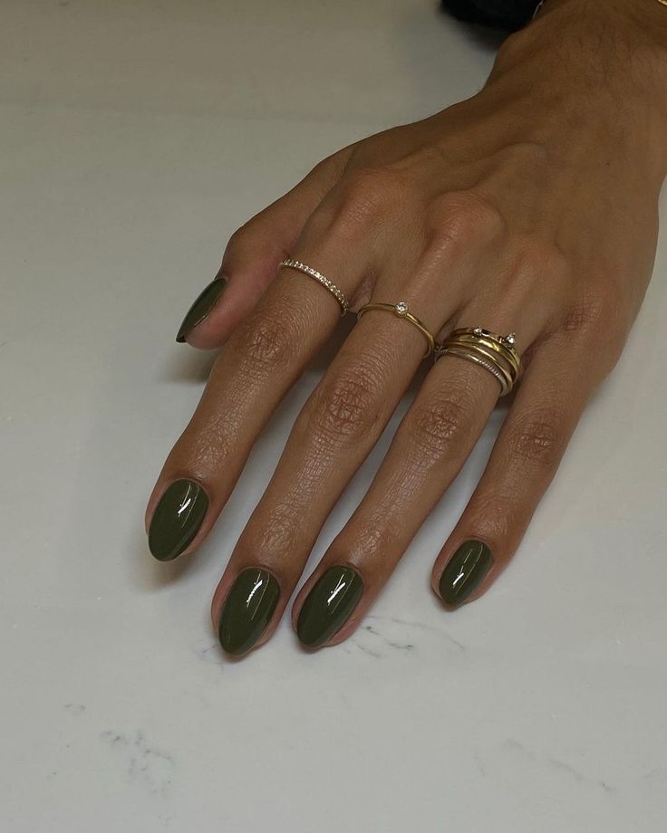 Elegant Olive Green Nail Design: Glossy Almond Shape with Delicate Gold and Silver Accents.