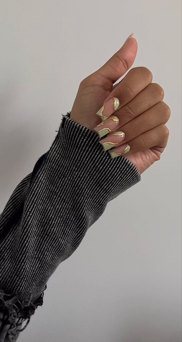 Elegant Nude and Gold Accented Nail Design for Sophistication.