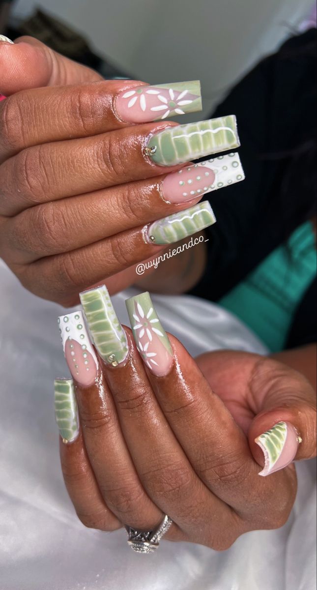 Whimsical Green Nail Design: Elegant Floral and Geometric Patterns.