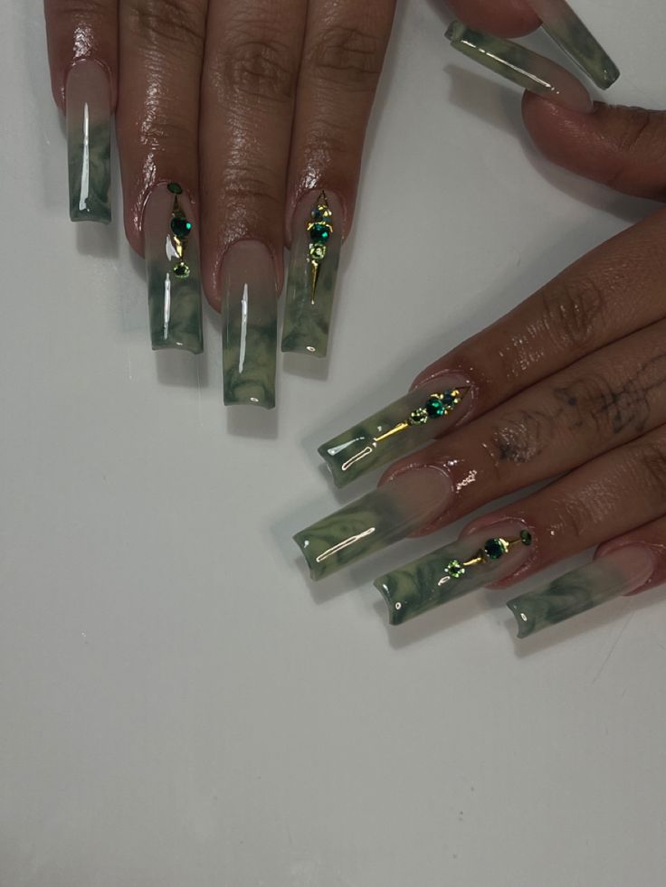 Elegant Green Marble Nail Design with Glossy Finish and Sparkling Embellishments.