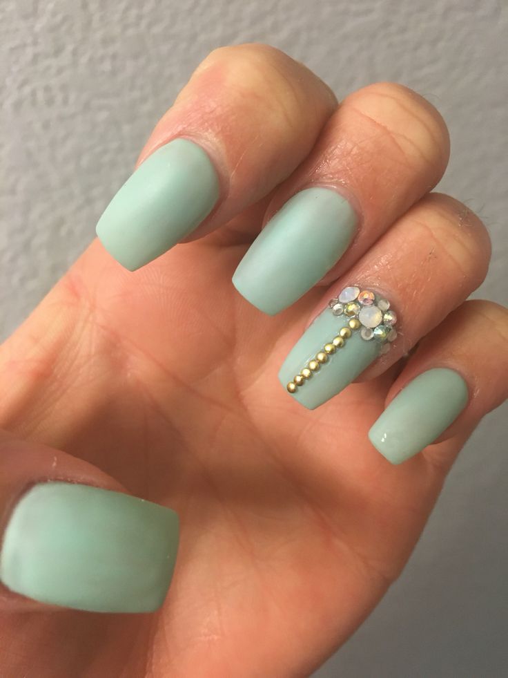 Chic Pastel Green Matte Nail Design with Elegant Gem Accents.