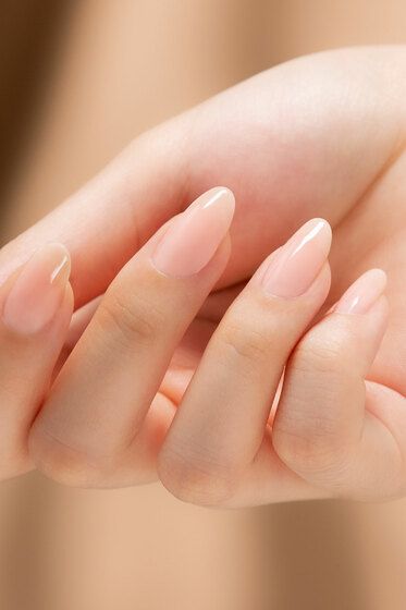 Elegant Almond-Shaped Nails with Soft Nude Polish for Timeless Sophistication