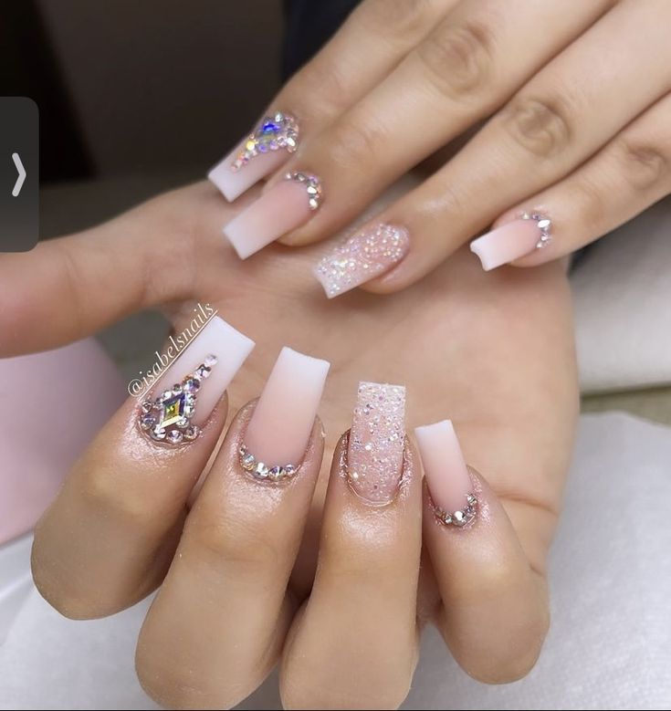 Elegant Nude and Pink Nail Design with Glitter Accents and Rhinestone Glamour.