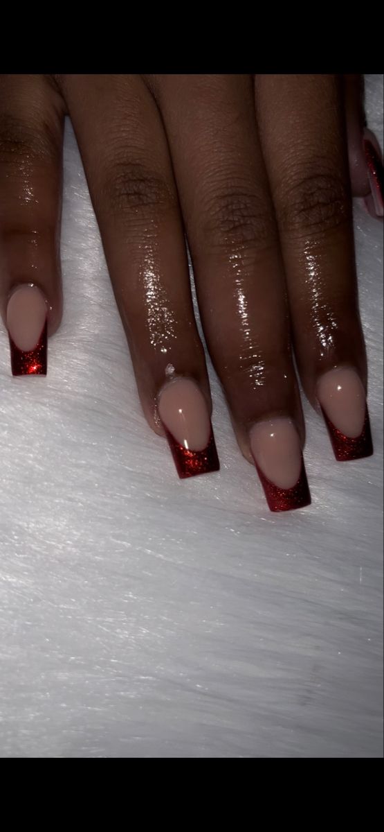 Chic Nude Nails with Striking Red Glitter Tips and Glossy Ombre Finish