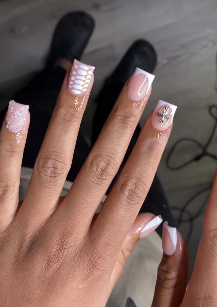 Elegant Soft Pink and White Textured Nail Design with Unique Patterns and Glamorous Accents.