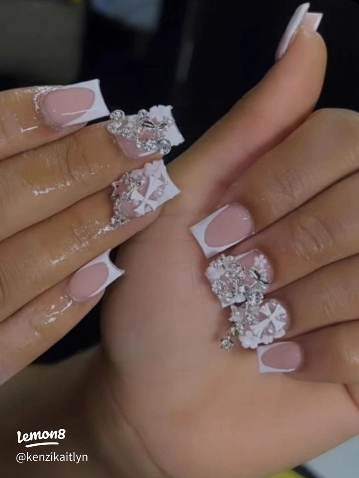 Sophisticated Nail Design: Soft Pink and Classic White Tips with Glamorous Embellishments for Special Occasions.