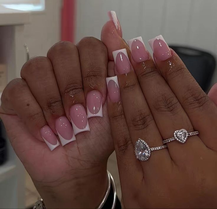 Chic French Manicure on Tapered Nails Enhanced by Sparkling Rings