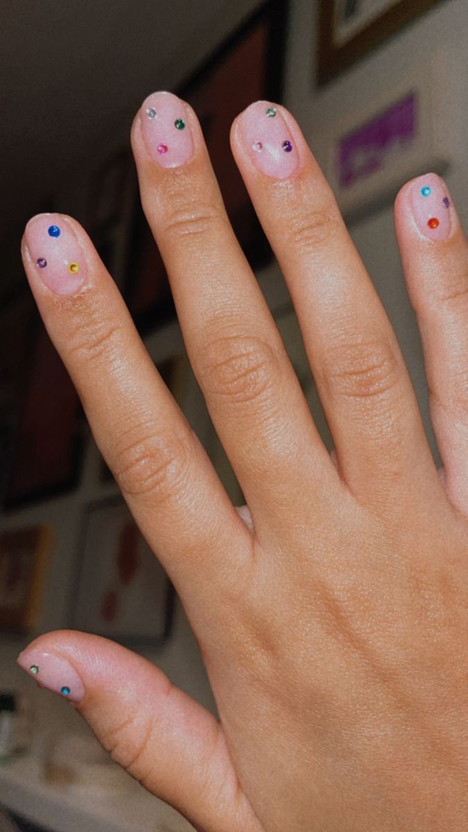 Chic Delicate Nude Nails Enhanced with Playful Colorful Rhinestones.