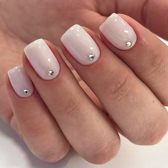 Sophisticated Minimalist Nail Design with Glossy White Finish and Subtle Metallic Accents.