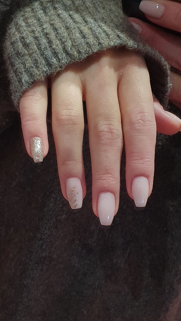 Chic Nude Nail Design with Glitter Accent for Versatile Glamour.