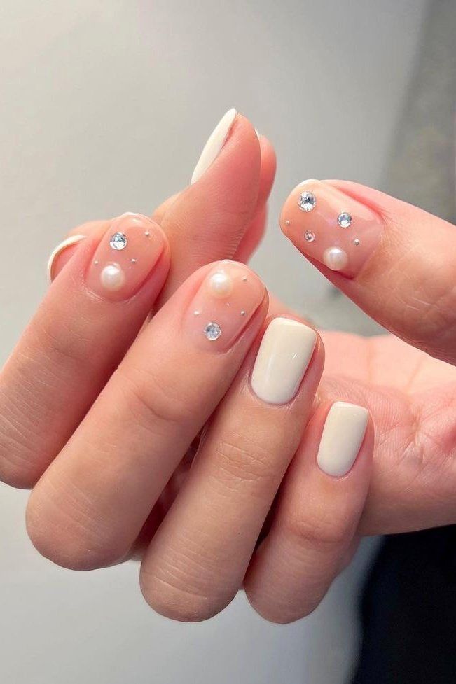 Chic Elegant Nail Design: Soft Neutral Base with Pearls and Crystals for Glamorous Occasions