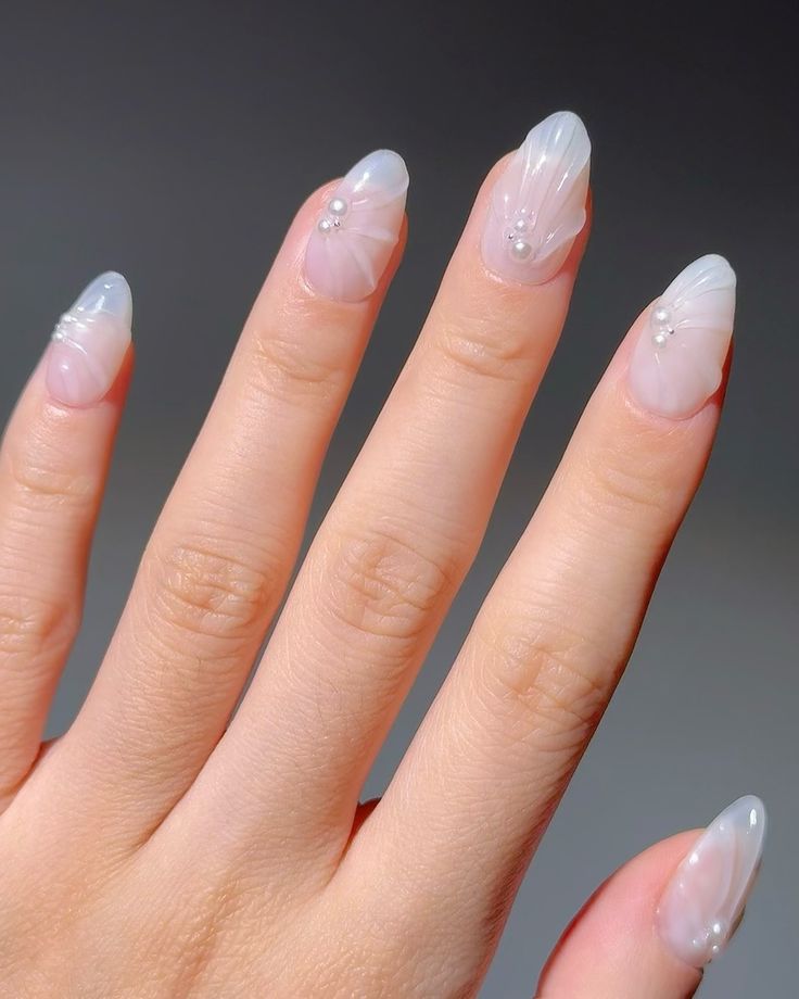 Chic Almond Nail Design with Sheer Base and Delicate White Accents