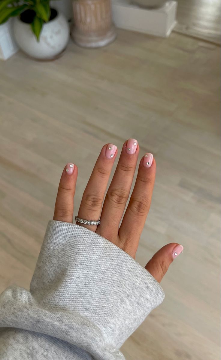 Chic Soft Pink Nail Design with Elegant White Dot Pattern.