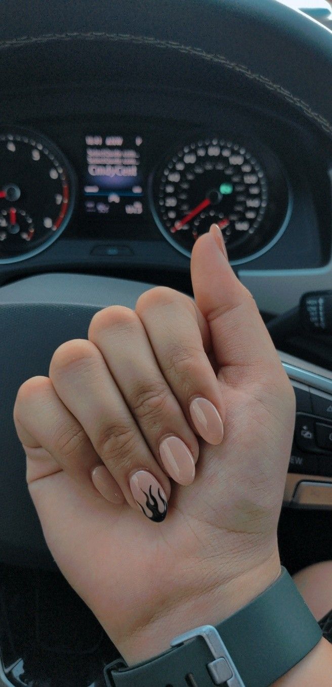 Chic Minimalist Nude Manicure with Bold Black Flame Accent on Almond-Shaped Nails.