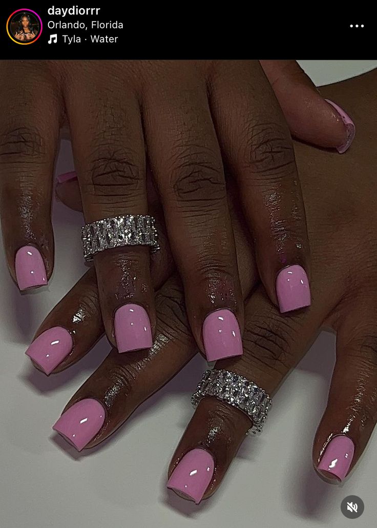 Playful Pink Nails with Sparkly Silver Rings: A Stylish and Sophisticated Choice for Any Occasion.